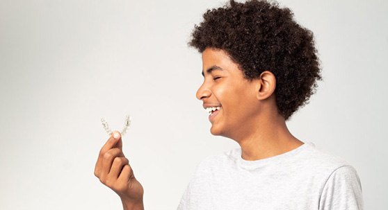 Teen marvels at his clear aligners?