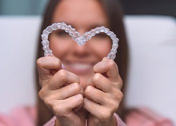 Woman holding two trays so that they form a heart